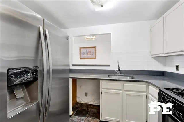 a kitchen with stainless steel appliances granite countertop a refrigerator and a stove