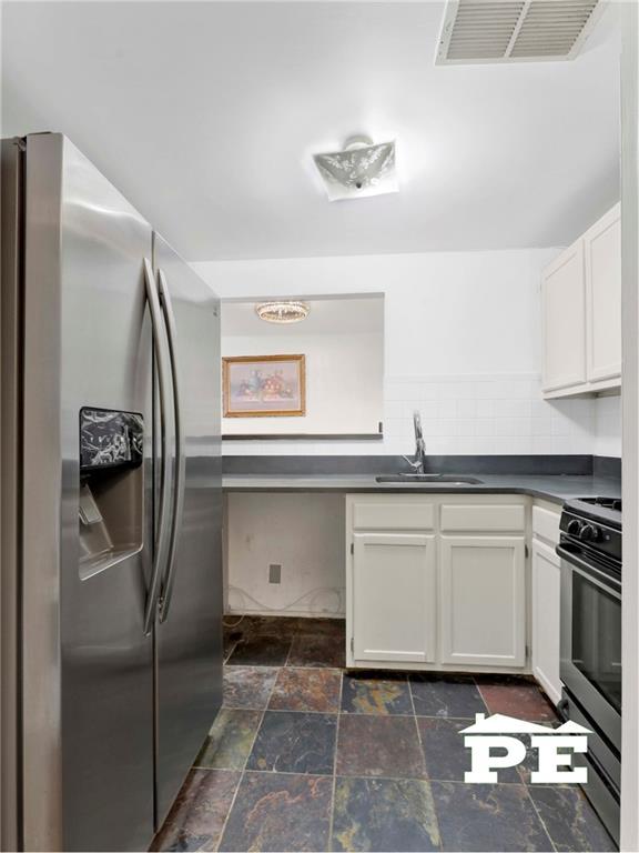 49 Erasmus Street, Unit 1A Brooklyn, NY 11226 - Photo 13 of 29 a kitchen with stainless steel appliances granite countertop a refrigerator and a stove