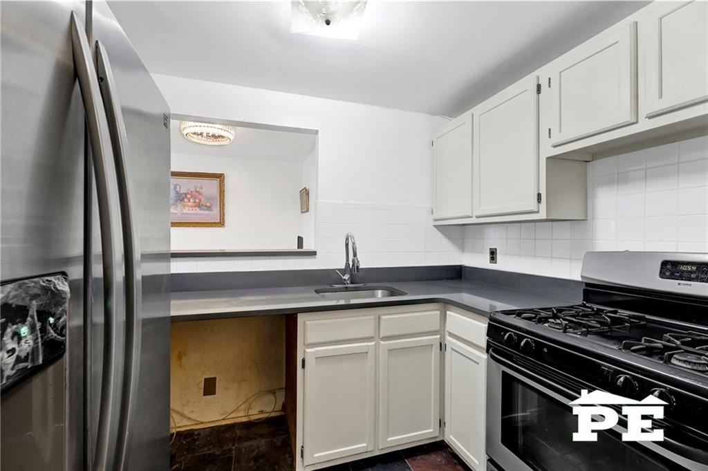 49 Erasmus Street, Unit 1A Brooklyn, NY 11226 - Photo 14 of 29 a kitchen with granite countertop a stove and a sink