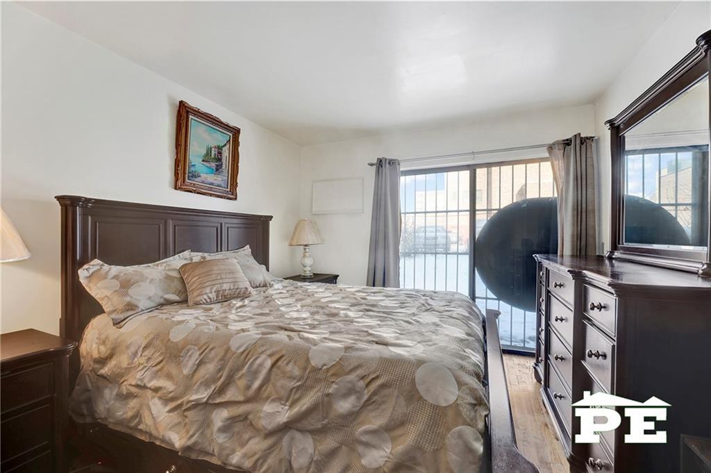 49 Erasmus Street, Unit 1A Brooklyn, NY 11226 - Photo 17 of 29 a bedroom with a bed and wooden floor