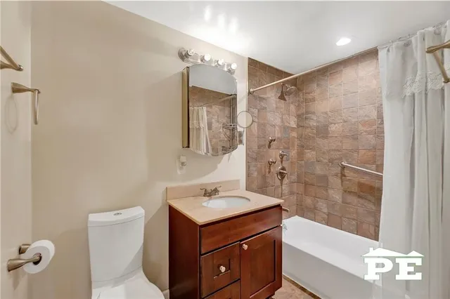 a bathroom with a sink mirror and a bathtub