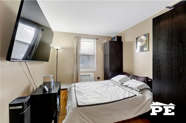 a bedroom with a bed and a tv