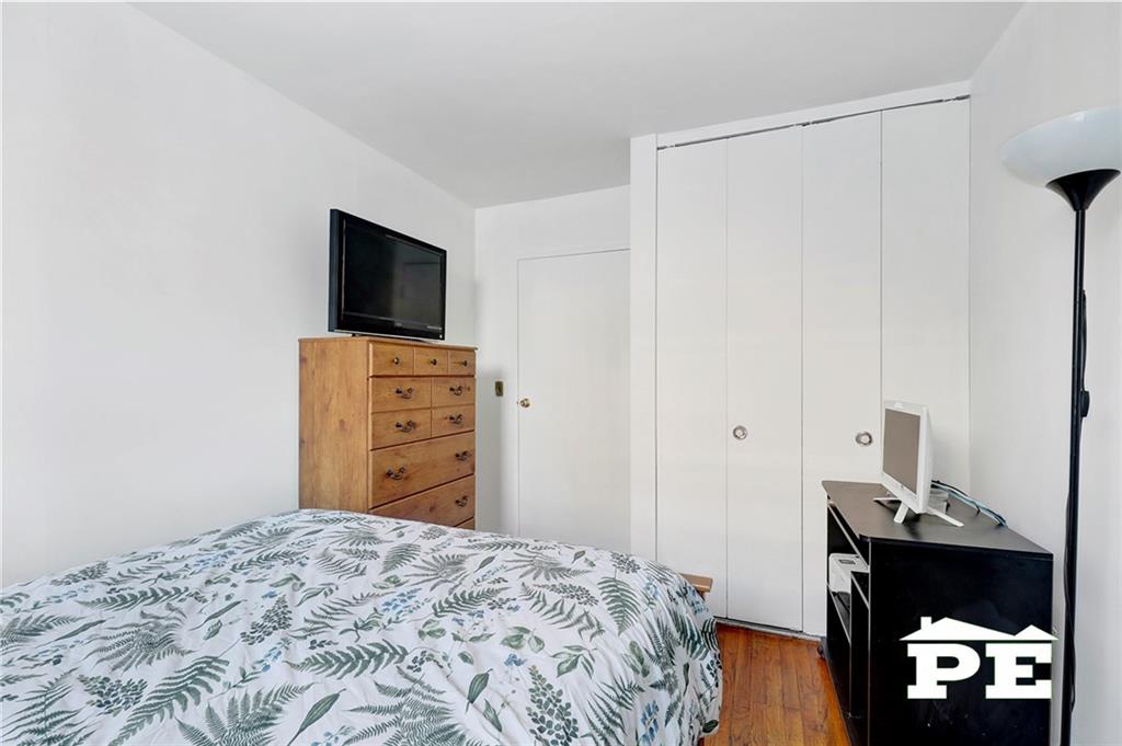 49 Erasmus Street, Unit 1A Brooklyn, NY 11226 - Photo 24 of 29 a bedroom with a bed and a tv on a dresser