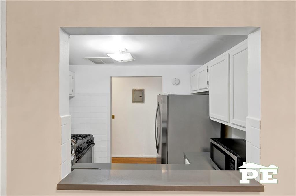 49 Erasmus Street, Unit 1A Brooklyn, NY 11226 - Photo 8 of 29 a kitchen with stainless steel appliances granite countertop a refrigerator and a stove