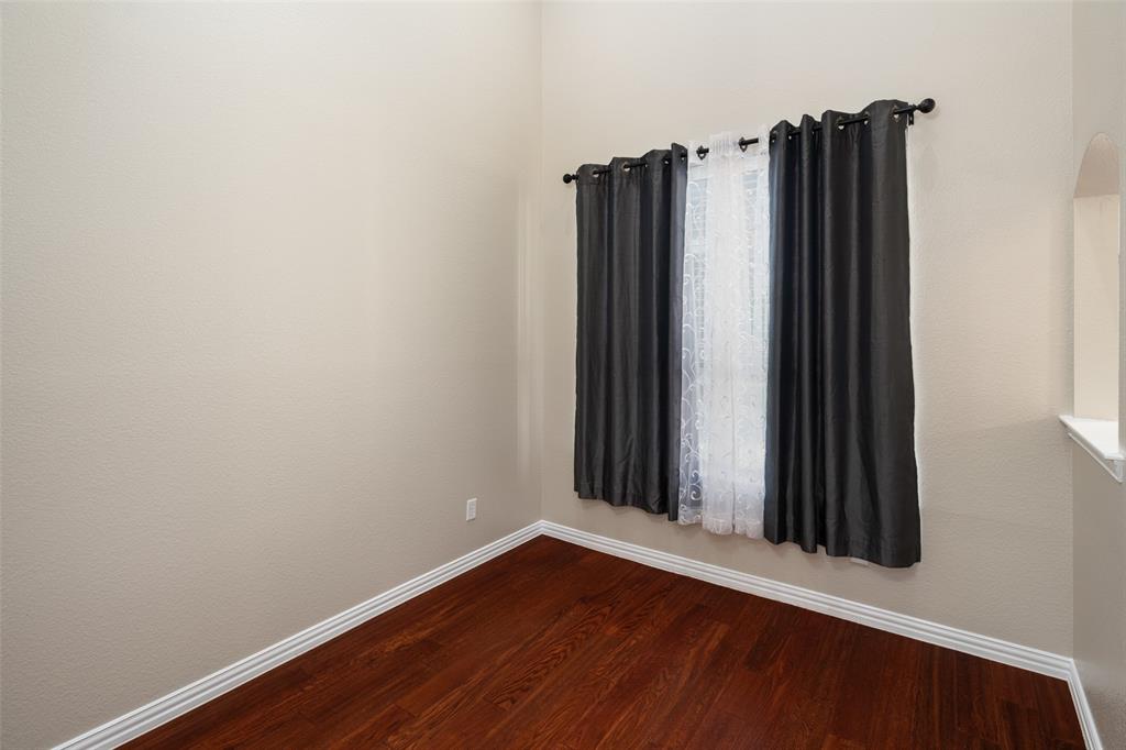 4245 Swan Forest Drive, Unit B Carrollton, TX 75010 - Photo 12 of 26 Empty room with baseboards and dark wood finished floors