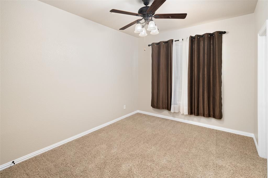 4245 Swan Forest Drive, Unit B Carrollton, TX 75010 - Photo 14 of 26 Carpeted empty room with ceiling fan and baseboards