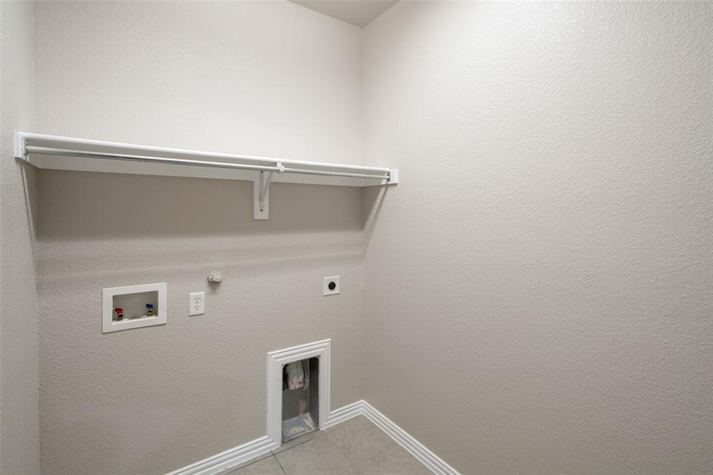 4245 Swan Forest Drive, Unit B Carrollton, TX 75010 - Photo 16 of 26 Laundry area with electric dryer hookup, gas dryer hookup, washer hookup, and light tile patterned floors