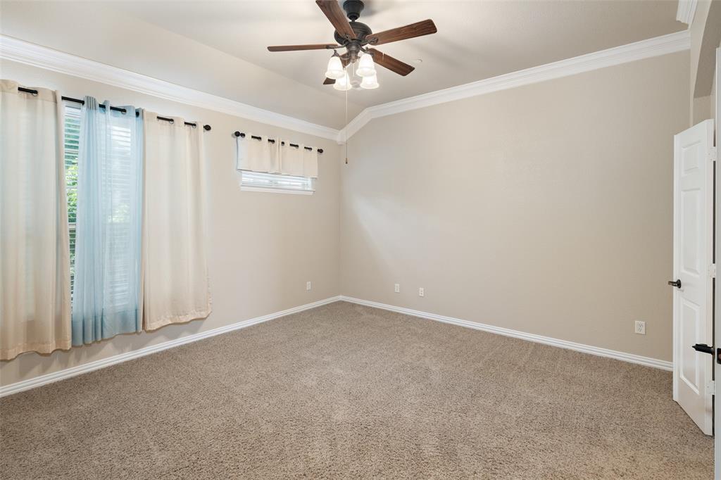4245 Swan Forest Drive, Unit B Carrollton, TX 75010 - Photo 17 of 26 Spare room with carpet flooring, a ceiling fan, and ornamental molding