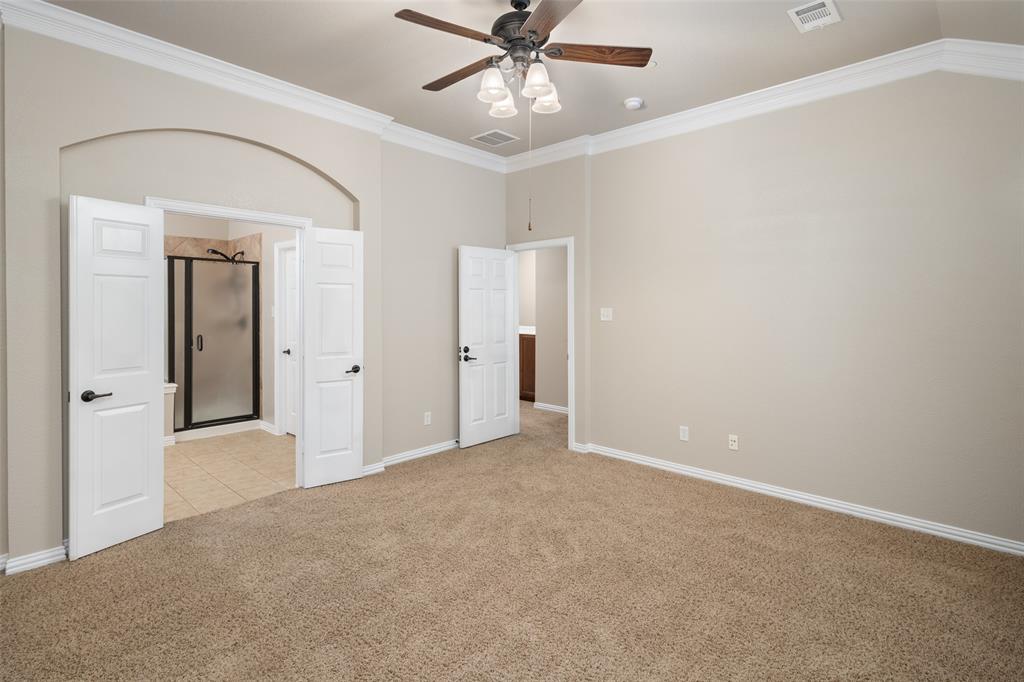 4245 Swan Forest Drive, Unit B Carrollton, TX 75010 - Photo 18 of 26 Unfurnished bedroom featuring light colored carpet, crown molding, ceiling fan, and light tile patterned floors