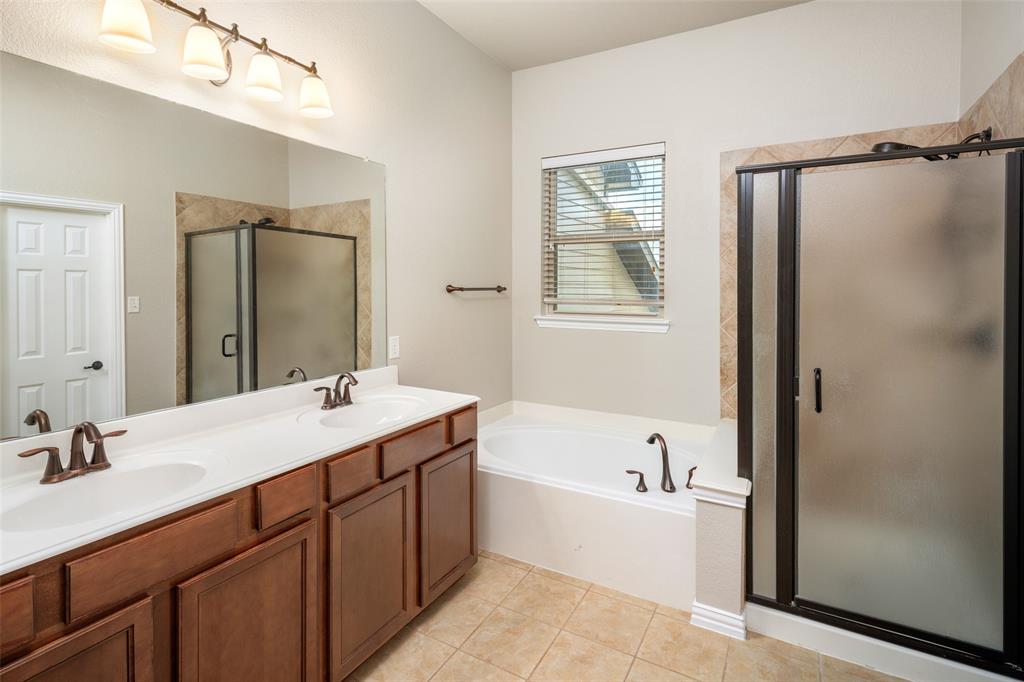 4245 Swan Forest Drive, Unit B Carrollton, TX 75010 - Photo 19 of 26 Bathroom with a shower stall, a bath, double vanity, and tile patterned floors