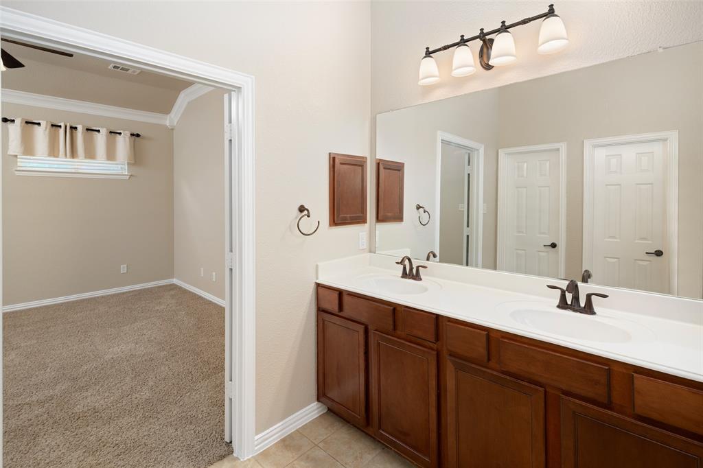 4245 Swan Forest Drive, Unit B Carrollton, TX 75010 - Photo 20 of 26 Bathroom featuring double vanity, ornamental molding, and tile patterned floors