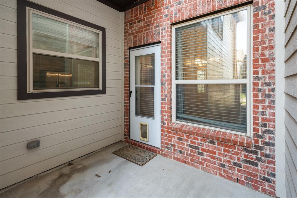 4245 Swan Forest Drive, Unit B Carrollton, TX 75010 - Photo 22 of 26 View of exterior entry featuring brick siding