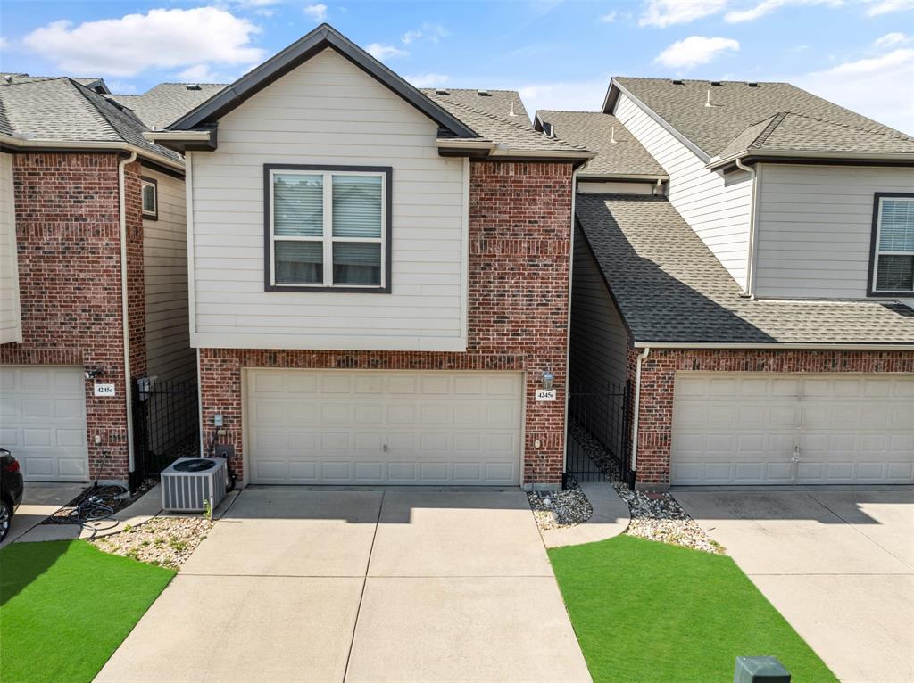 4245 Swan Forest Drive, Unit B Carrollton, TX 75010 - Photo 23 of 26 View of front of property featuring driveway, an attached garage, and brick siding