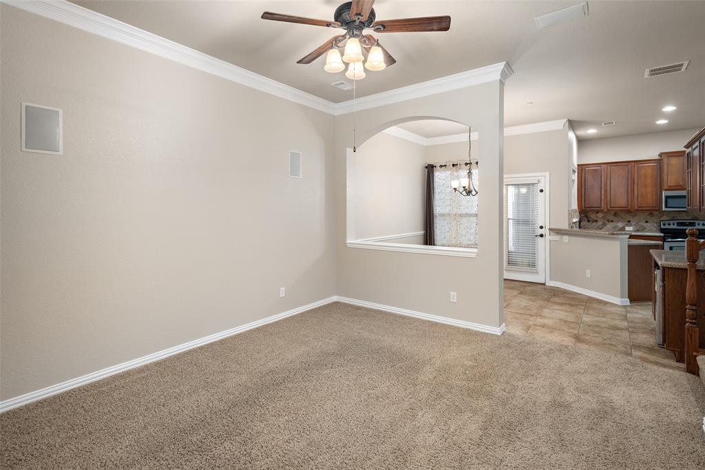 4245 Swan Forest Drive, Unit B Carrollton, TX 75010 - Photo 4 of 26 Unfurnished living room featuring ceiling fan, ornamental molding, light carpet, recessed lighting, and arched walkways