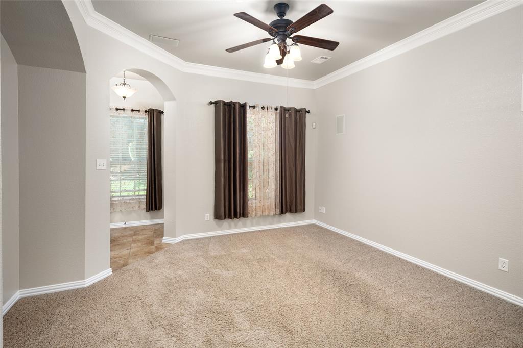4245 Swan Forest Drive, Unit B Carrollton, TX 75010 - Photo 5 of 26 Spare room featuring ceiling fan, arched walkways, carpet flooring, and ornamental molding