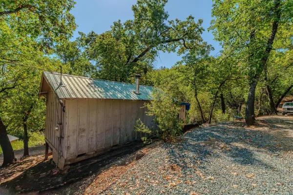 a view of a small house with wooden fence
