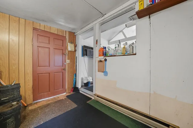 a view of kitchen with furniture and electronic appliances