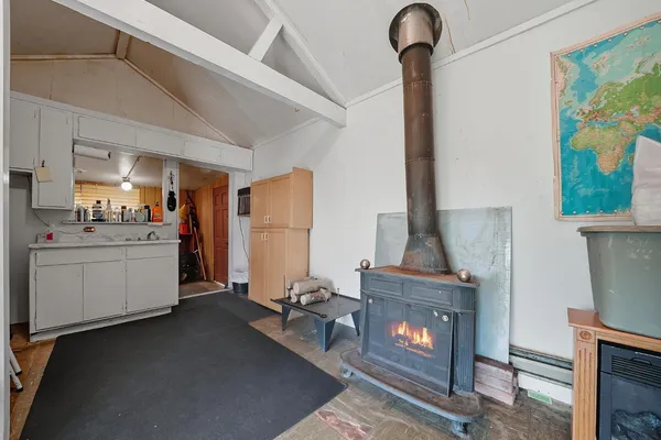 a bedroom with a bed and a large mirror on the dresser