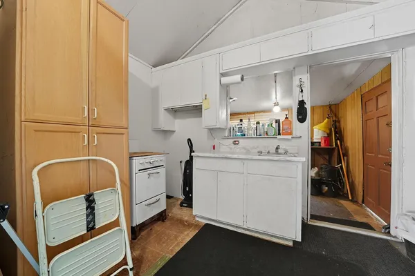 a utility room with cabinets washer and dryer