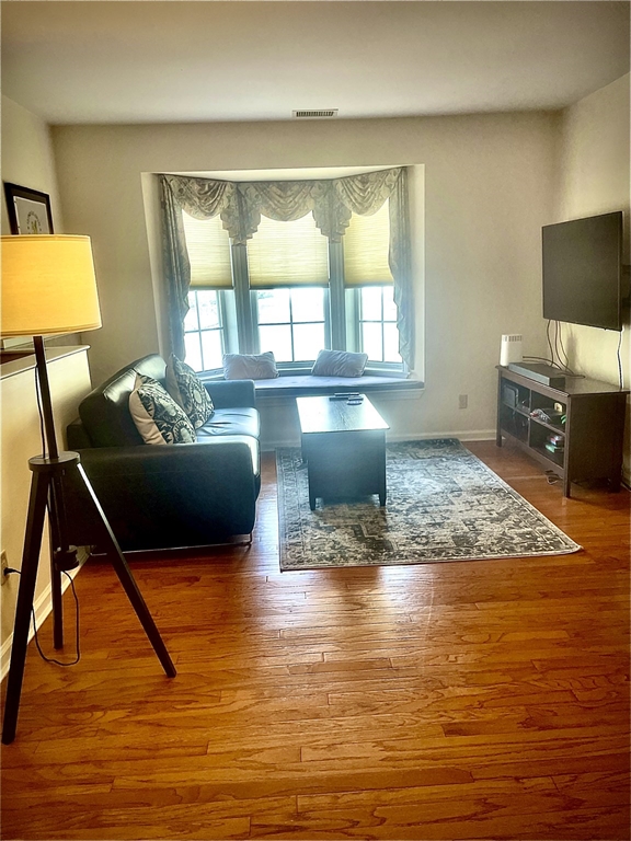 208 Gazebo Circle, Unit 208 Reading, MA 01867 - Photo 4 of 10 a living room with furniture and a flat screen tv