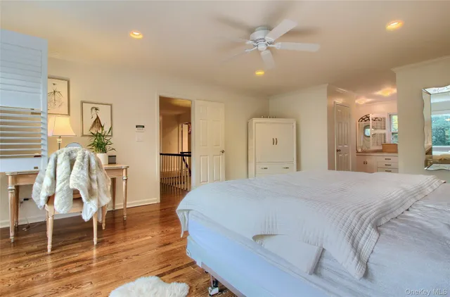 a spacious bedroom with a bed and a wooden floor
