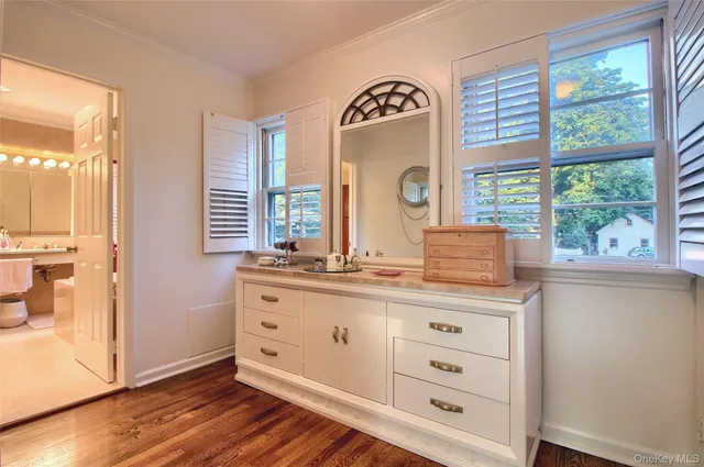 a room with a window and a dresser