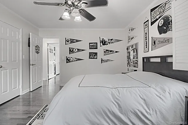 a bedroom with a large bed and a chandelier