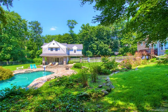 a view of a house with a yard and garden