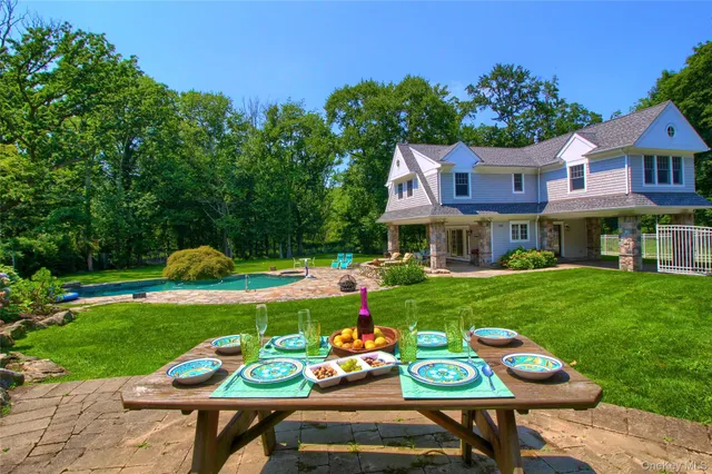a view of an chairs and table in a yard