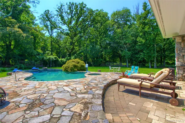 a view of a backyard with swimming pool