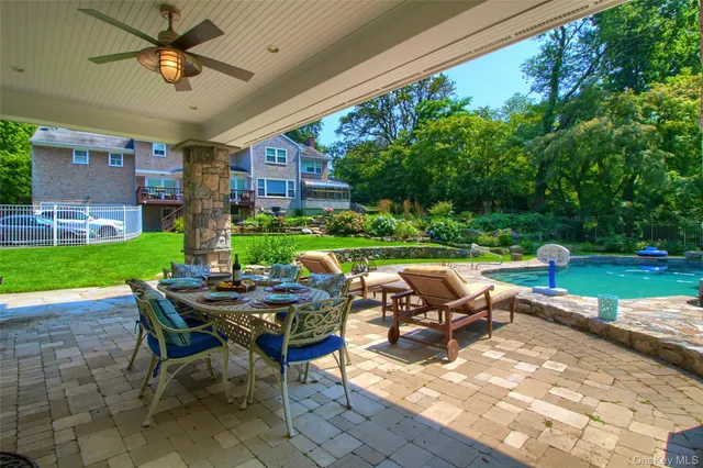 a view of a patio with table and chairs under an umbrella