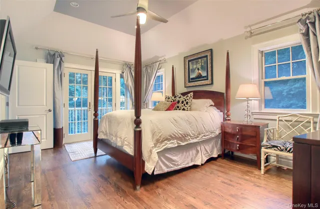 a bedroom with a bed wooden floor and window