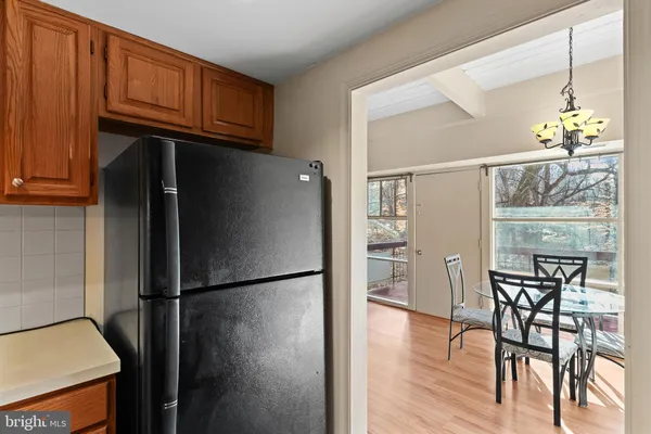 a kitchen with stainless steel appliances granite countertop a refrigerator a microwave and wooden floor