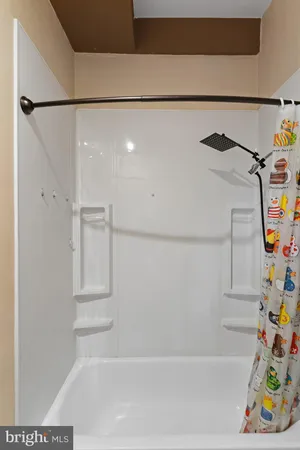 a bathroom with a window and a shower