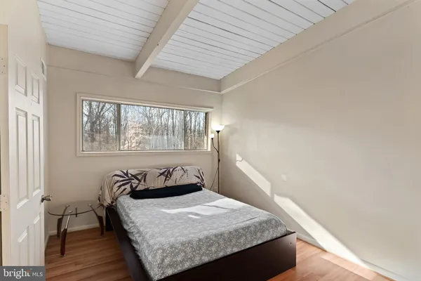 a bed sitting in a bedroom next to a window