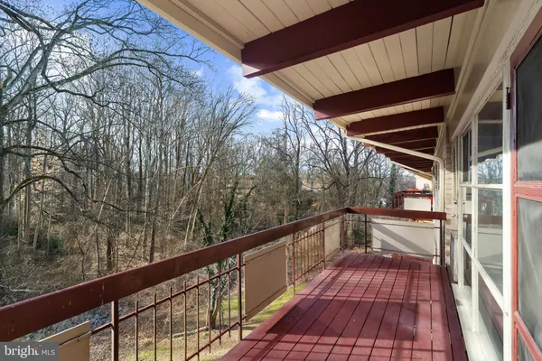 a view of balcony with wooden floor and yard