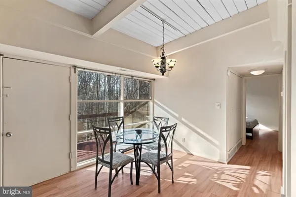 a view of a room with furniture and wooden floor