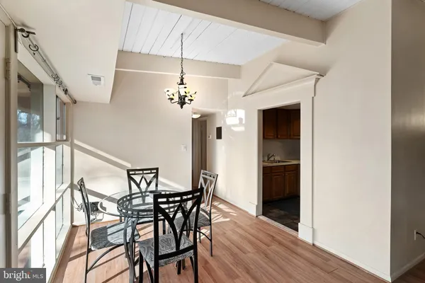 a view of a dining room with furniture and chandelier