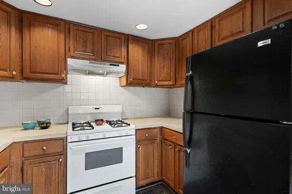 a kitchen with a refrigerator stove and cabinets