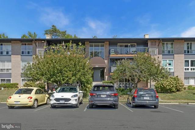 a view of a cars park in front of a building