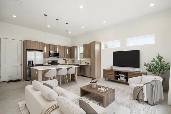 a large kitchen with stainless steel appliances granite countertop a refrigerator and a sink
