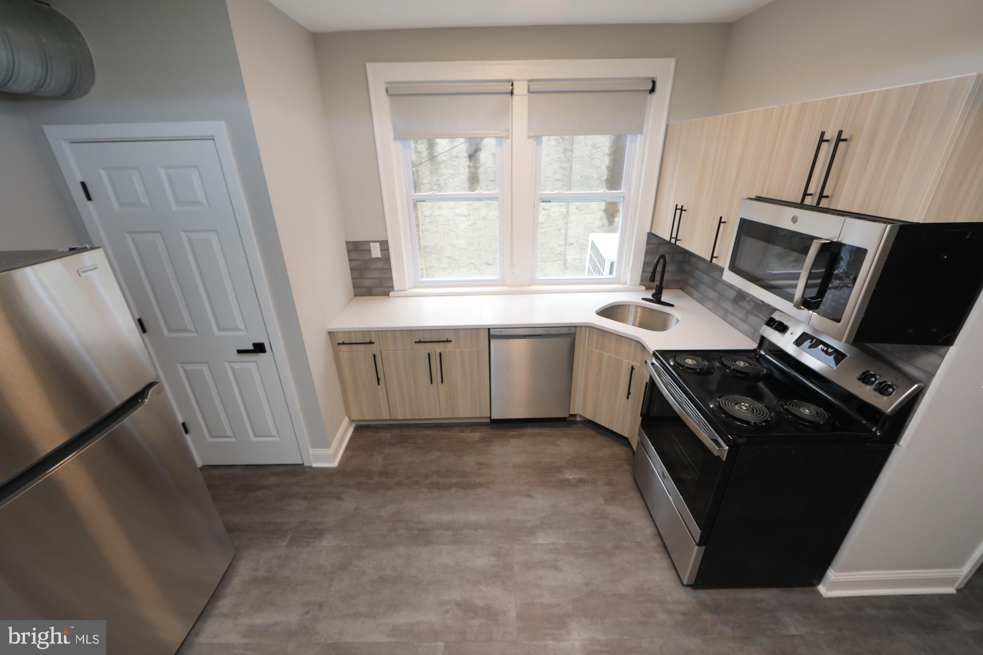 a kitchen with a sink stove and cabinets