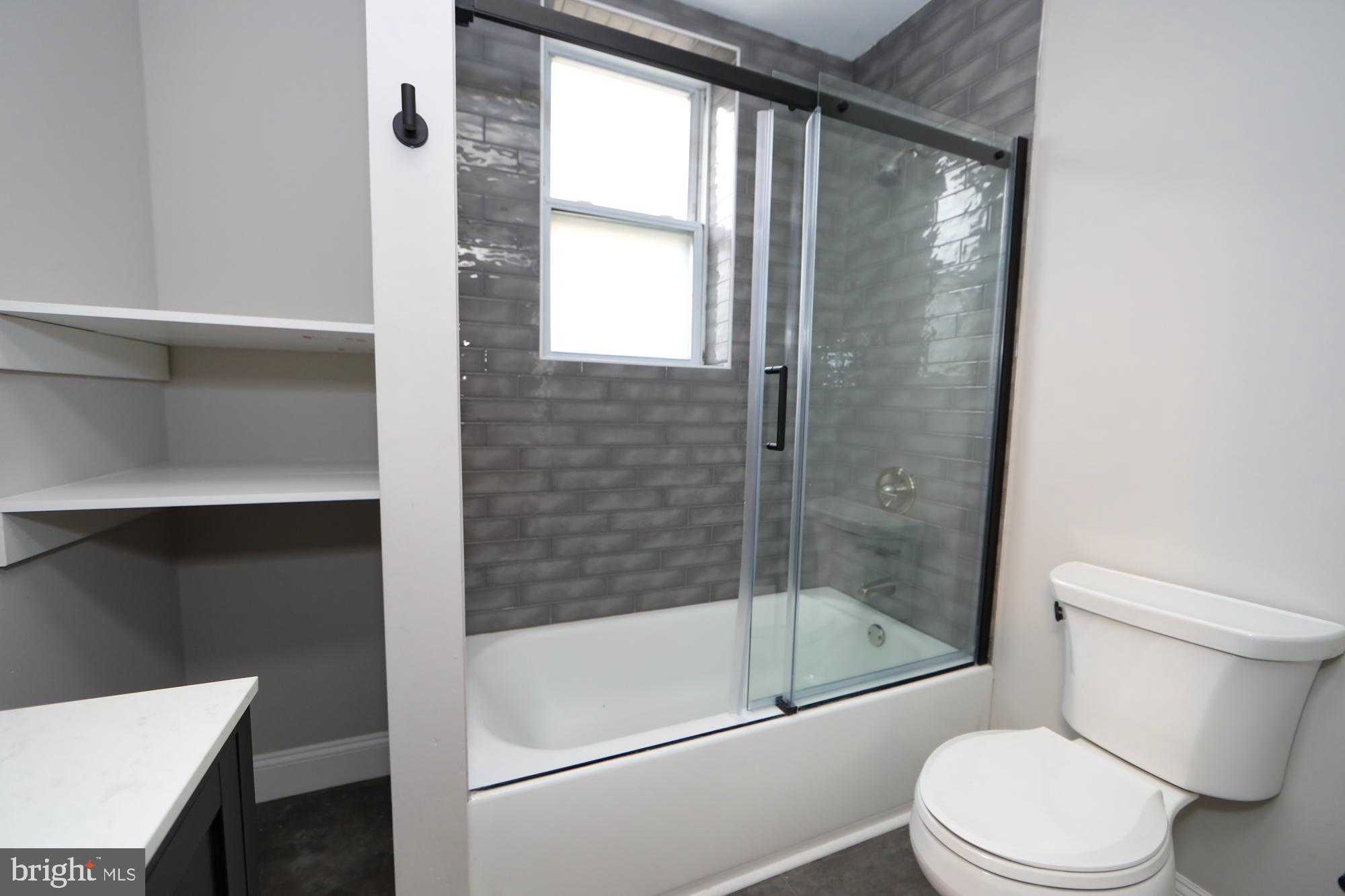 931 Spring Garden Street, Unit 2 Philadelphia, PA 19123 - Photo 15 of 24 a bathroom with a shower a toilet and a sink