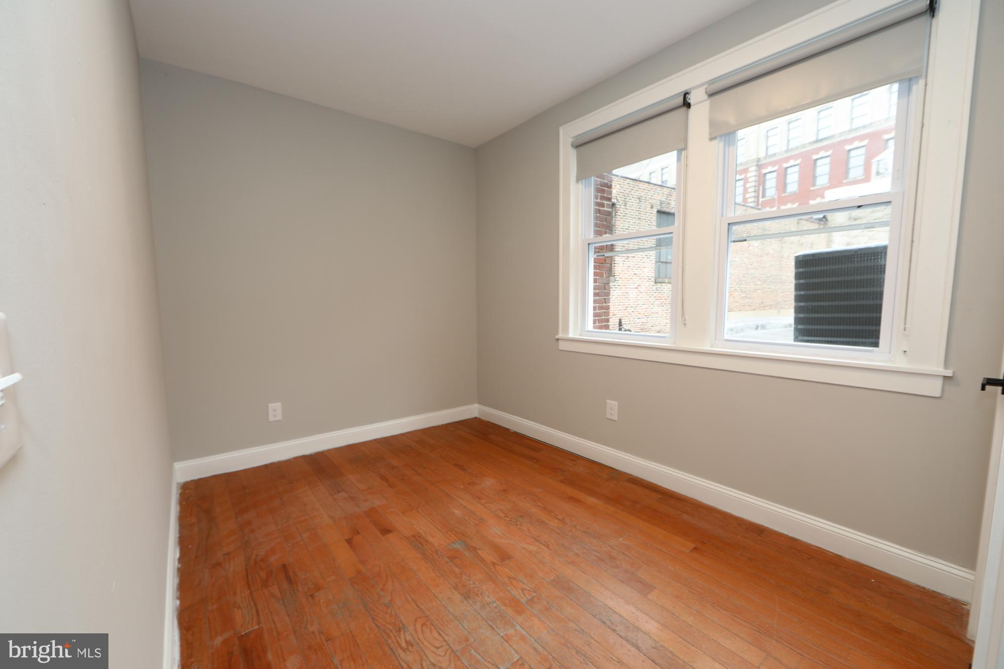 931 Spring Garden Street, Unit 2 Philadelphia, PA 19123 - Photo 8 of 24 an empty room with a window