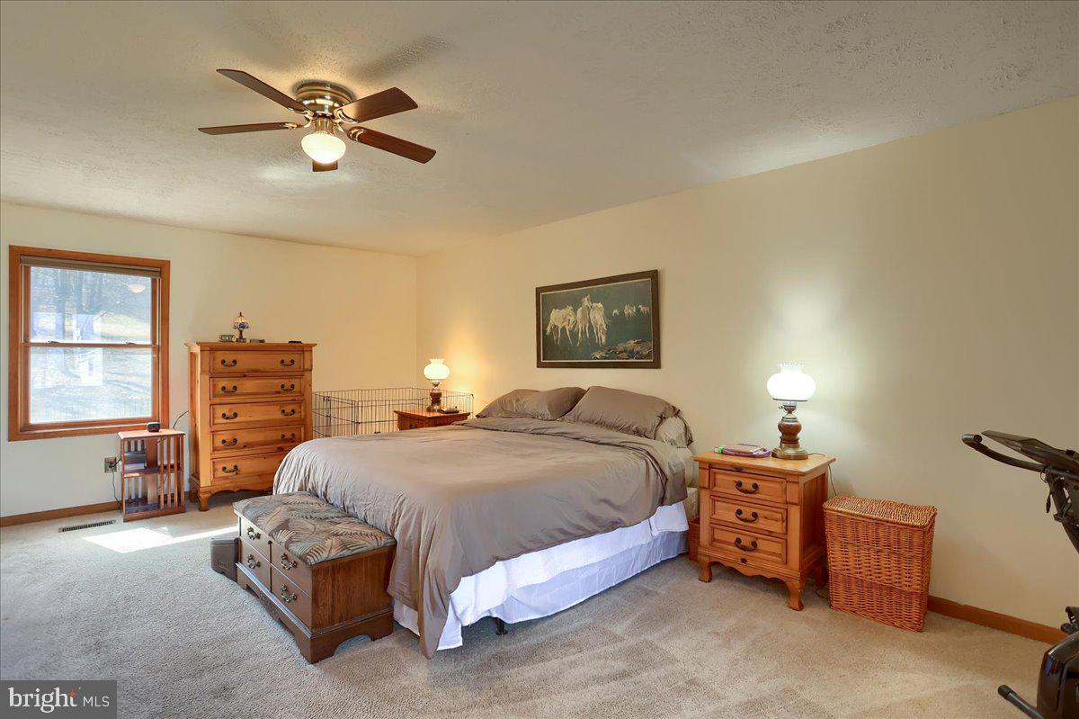 75 Thunder Trail Fairfield, PA 17320 - Photo 34 of 64 a bedroom with a bed and a chandelier