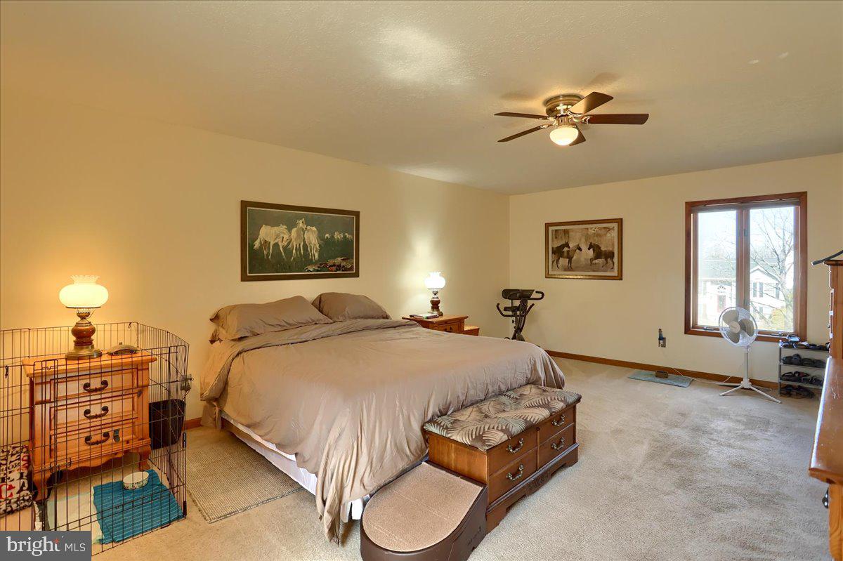 75 Thunder Trail Fairfield, PA 17320 - Photo 35 of 64 a bedroom with a bed and a chandelier