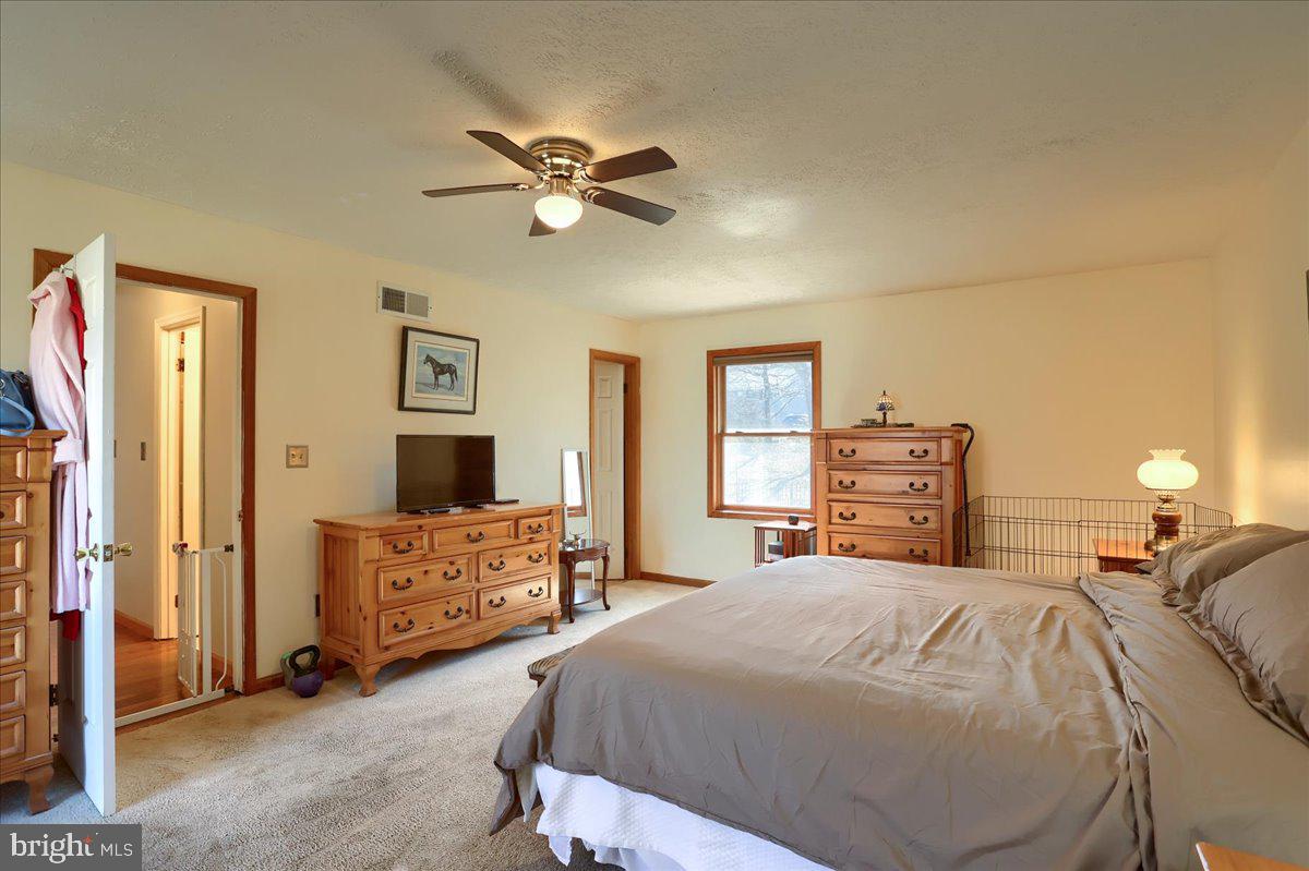 75 Thunder Trail Fairfield, PA 17320 - Photo 36 of 64 a bedroom with a bed and dresser with mirror