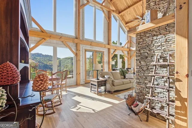 a living room with furniture and floor to ceiling windows