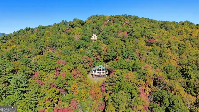 a bedroom with a bed and a flat tv screen on dresser