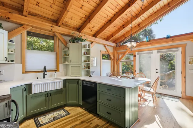 a kitchen with a sink appliances and a large window